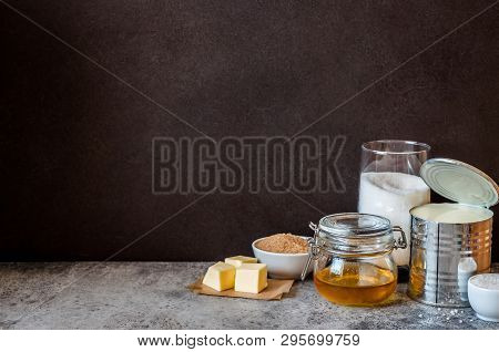 Sea Salt Caramel Candy Ingredients Near A Blackboard To Whrite The Recipe On, Copy Space For Your Te