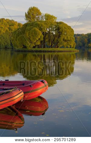 Inflatable Red Boats On Water On The River Or Lake Near The Shore In A Clear Summer Day