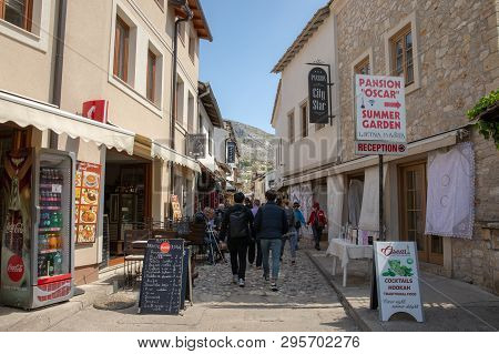 Mostar, Bosnia And Herzegovina - April, 2019: Mostar Old Town. Tourists Walking Into The Market Stre