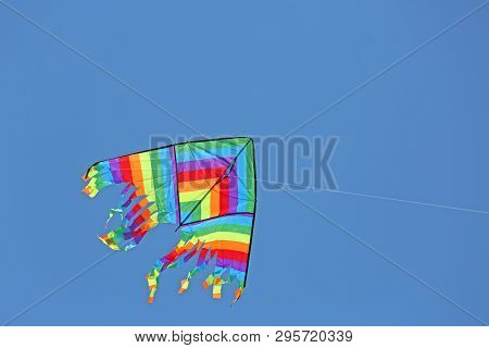 Multcolored Kite On The Blue Sky.  This Is The Symbol Of Freedom And Happy Childhood
