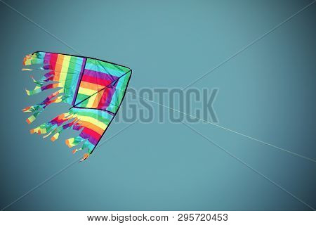 Multcolored Kite On The Blue Sky With Vivid Colors And Old Toned Effect