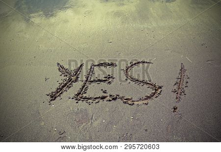 Text Yes On The Beach Sand With Toned Old Effect