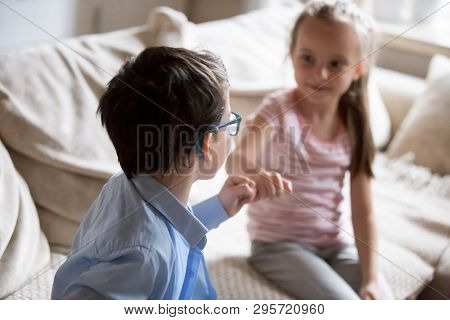 Brother And Sister Squeeze Little Fingers As Sign Of Reconciliation