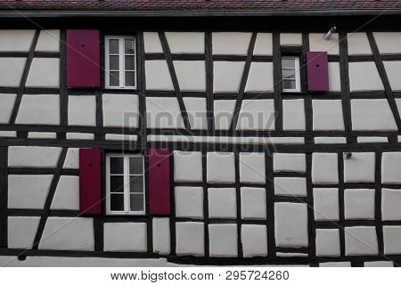 White Wall Of A Traditional Old Half-timbered House. Alsace. France. There Are Black Beams, Windows 