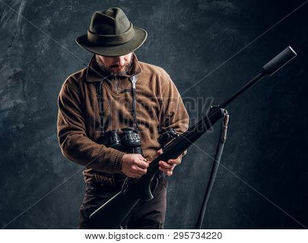 Opening Of The Spring Hunting Season. Hunter Ready To Hunt And Charging A Hunting Rifle. Studio Phot