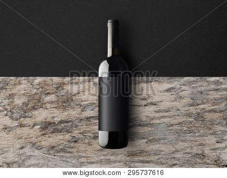 Dark Wine Bottle On A Black And Wooden Background With Copy Space. Wine Bottle Mockup. Top View.