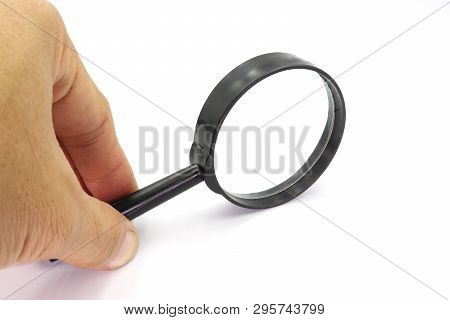 Hand Holding Magniflying Glass Isolated On White Background. High Resolution Image Gallery.