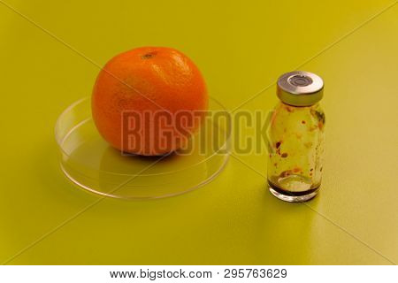 Ripe Tangerine And A Medicine Bottle On A Green Table. Laboratory Work On Fruit. Citrus Tests For Th