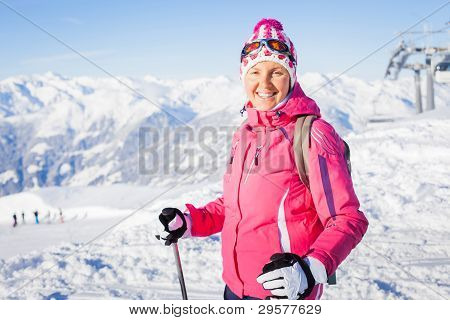 Young woman with skis and a ski wear
