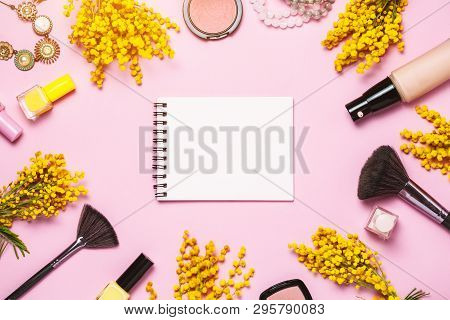 Yellow Spring Flowers, Notebok And Some Cosmetics On Pink Spring Background