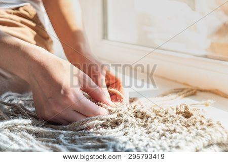 Making A Diy Hemp Bag. Woman Hands Knitting An Acessory Out Of Natural Jute Rope, Close-up View And 