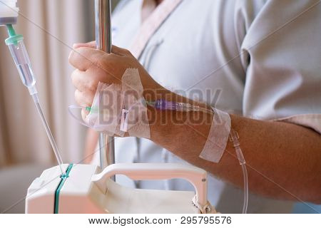 Close-up. Male Hand With A Dropper During Chemotherapy In A Hospital. Hand With A Dropper. Health Is