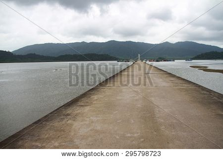 Cement Jetty Bridge Stretches To The Sea. Used For The Docking Of Ships, After Finding Out The Fish.