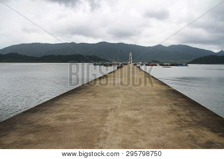 Cement Jetty Bridge Stretches To The Sea. Used For The Docking Of Ships, After Finding Out The Fish.