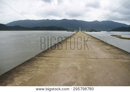 Cement Jetty Bridge Stretches To The Sea. Used For The Docking Of Ships, After Finding Out The Fish.