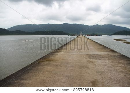 Cement Jetty Bridge Stretches To The Sea. Used For The Docking Of Ships, After Finding Out The Fish.