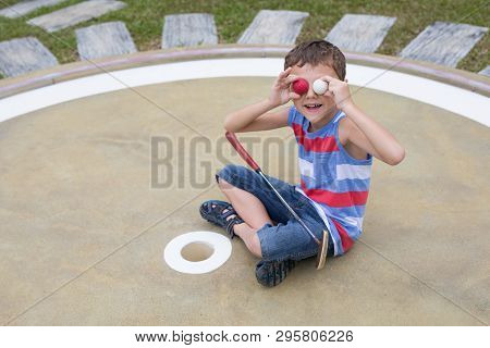 Happy Little Boy Playing Mini Golf Playing Mini Golf