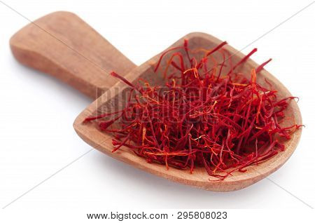 Saffron In A Wooden Scoop Over White Background