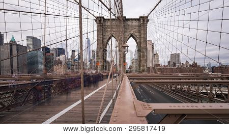 The Brooklyn Bridge At Daytime With The Camera Pointing Towards New York City. A Long Exposure With 