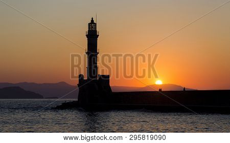 The Silhoutte Of The Lighthouse In The Harbor Of Chania, A City On The Island Of Crete, Greece Durin