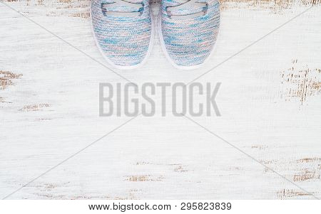 Top View Of Pair Of Trendy Sport Sneakers On Gruge White Wood Background. Flat Lay Top View With Cop