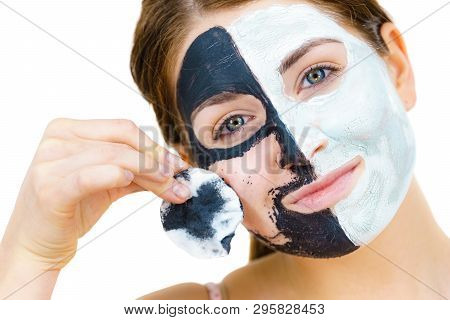 Woman With Clay Carbo Black Mask On One Half Face And White Mud On Second Half. Girl Removing Cosmet