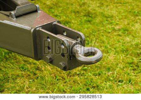 Close Up On Dark Towbar In Agricultural Machine Vehicle. Green Grass In Backround.