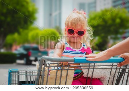 Shopping With Kids- Cute Little Girl In Shopping Cart In The City