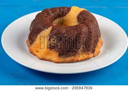 Kuglof On The White Plate And Blue Background