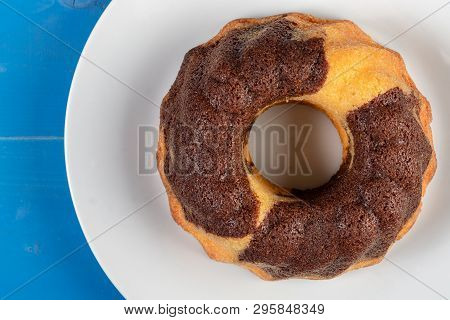 Kuglof On The White Plate And Blue Background