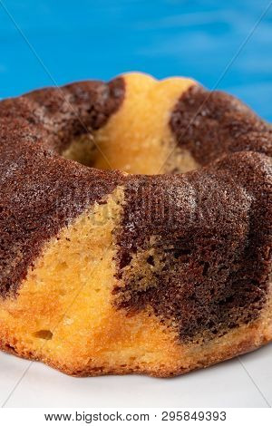 Kuglof On The White Plate And Blue Background