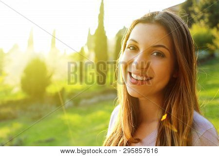 Smiling Girl Outdoors Backlit By Sun, Shot With Flares. Close Up Woman Portrait Outdoor. Beautiful Y