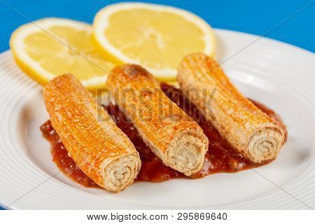 Fried Surimi Sticks With Lemons On The Blue Wooden Boards