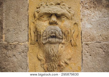 Barcelona, Spain, August 11 2018: Bas Relief Decorative Mask Sculpture On The Walls Of Famous Comedi