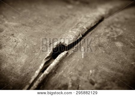 Defect - A Crack In The Pipeline Pipe. Photographed In Ukraine. Kiev Region. Horizontal Frame. Black