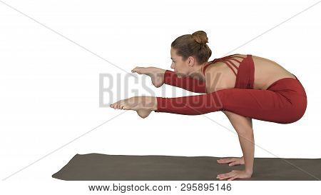 Beautiful Young Fit Woman Wearing Sportswear Doing Handstand, Variation Of Firefly Posture, Tittibha
