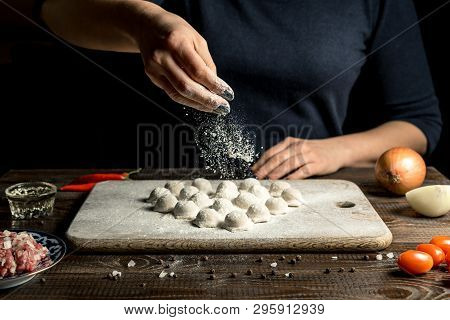 Uzbek National Food Chuchvara, Like Dumplings, Lie In The Shape Of A Heart, On A Wooden Board, Hands