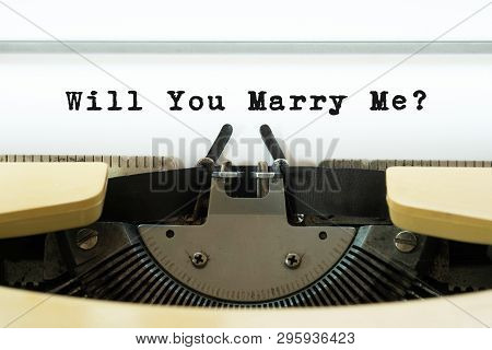 Will You Marry Me Word On A Yellow Vintage Typewriter. Valentines Day Concept. Marriage And Wedding 