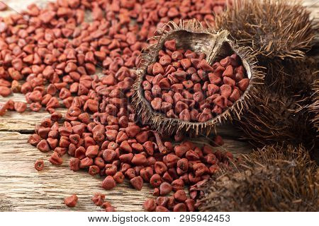 Annatto Seeds On Rustic Wood