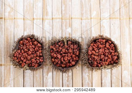 Annatto Seeds On Rustic Wood