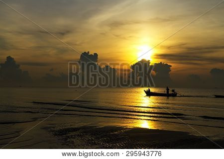 Sunrise In The Sea And Fisherman On Beach At Thung Wua Lan Beach, Chumphon Province Thailand