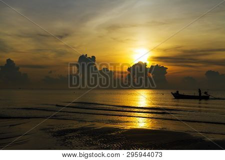 Sunrise In The Sea Silhouette Fisherman On Beach At Thung Wua Lan Beach, Chumphon Province Thailand