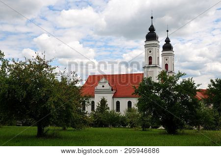 View Over Orchard To Monastery Church Of Irsee, Baroque Landmark In The Region Of Allgaeu In Souther