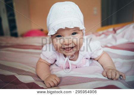 Portrait Of A Newborn Baby With His Tongue Sticking Out