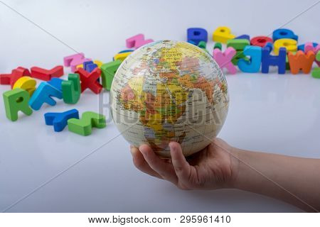 Little Model Gobe In Hand With Colorful Letters Behind