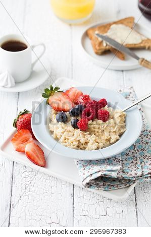 Breakfast Oatmeal Porridge With Fruits Berries And Coffee Cup. Oatmeal With Strawberries And Berry. 