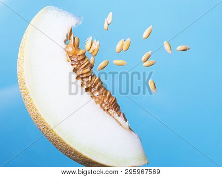 Ripe Melons With Fresh Melon Seeds  On Blue Background.