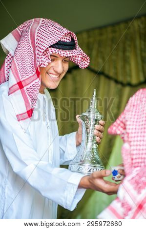 Arbic boy pouring coffee