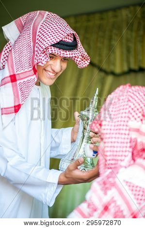 Arbic boy pouring coffee