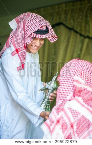 Arbic boy pouring coffee